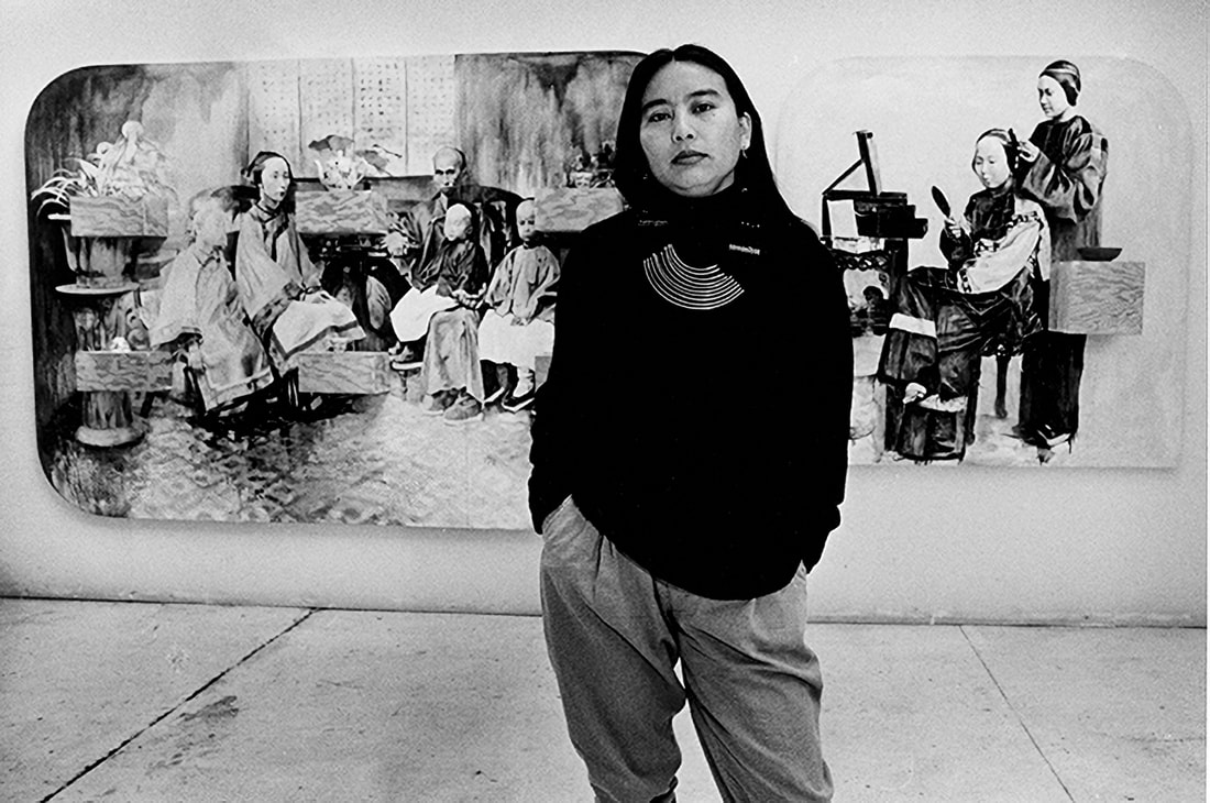 Hung Liu standing in front of her art. 